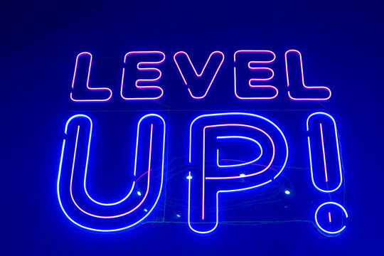 Retro video games zone. Neon sign: Level Up!