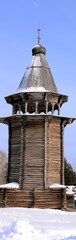 A wooden bell tower in the North of Russia. A vertical panorama of 12 frames. Handmade work.
