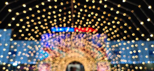 Closeup abstract of Glowing Blurred Bokeh Golden Serial light pattern isolated in a background.