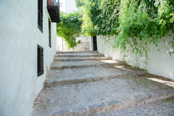 The architecture of the island of Ibiza. A charming empty white street in the old town of Eivissa
