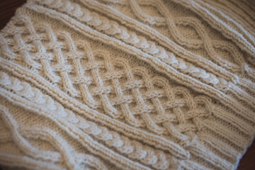 Detail of intricately knit aran-style sweater with cable knitting