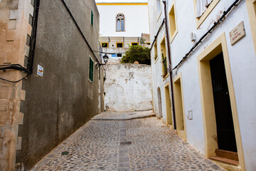 The architecture of the island of Ibiza. A charming empty white street in the old town of Eivissa