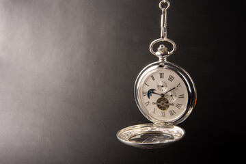 Pocket watch, beautiful details of a pocket watch, dark gradient background, selective focus.