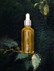 cosmetic serum bottle on natural background with water drops organic cosmetics