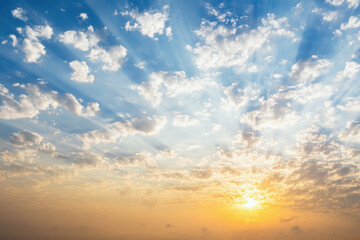 Beautiful blue sky with clouds, sunset and sunbeams