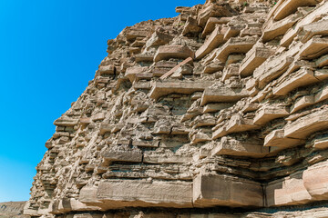 Layered stone mountain. Natural stone background