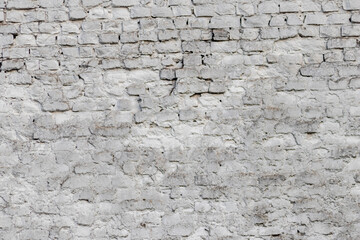 Solid wall with white bricks in vintage style as grey stonewall background or wallpaper with urban house architecture seamless aged in rectangle tiled stone texture and modern rough surface material