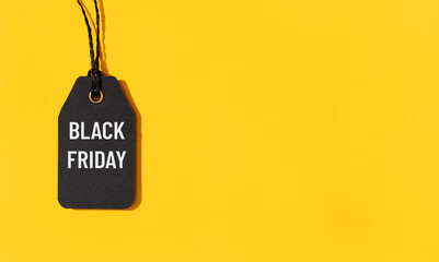 Black friday tag isolated on yellow background with copy space