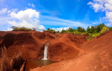 Red dirt with small waterfall on Kauai