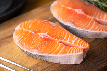 fresh salmon steak on wooden cutting board