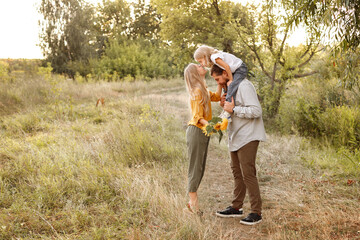 a girl kisses her mother on a walk in nature. happy family