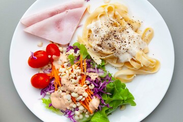 Western breakfast plate, salad, pasta and ham