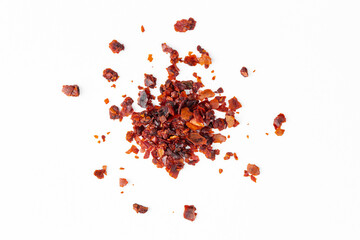 crushed red pepper flakes isolated on white background closeup, macro