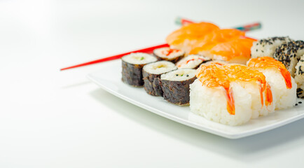 Set of smoked salmon nigiri, Ebi king prawn nigiri, sweet chilli pawn and red pepper California roll, cucumber with wasabi hosomaki roll and red pepper hosomaki roll