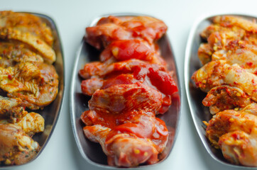 Three different set of the chicken wings with sriracha glaze, Caribbean marinade and Chinese glaze