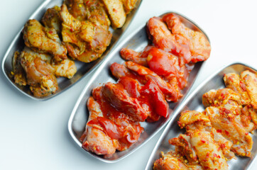 Three different set of the chicken wings with sriracha glaze, Caribbean marinade and Chinese glaze