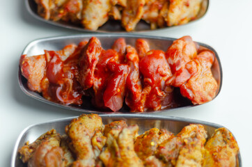 Three different set of the chicken wings with sriracha glaze, Caribbean marinade and Chinese glaze