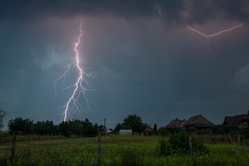 A powerful bolt of lightning strikes near a village in Romania