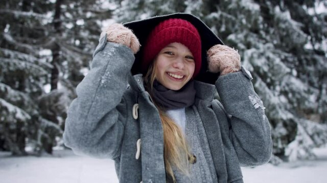 Front view of of preteen girl outdoors in winter nature, copy space.