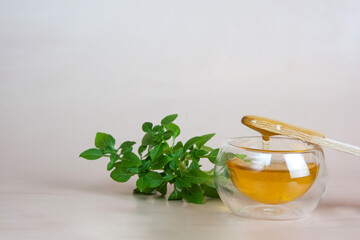 Depilation and beauty concept - sugar paste or wax, honey for hair removal drips from wooden wax sticks in a jar on a floral background
