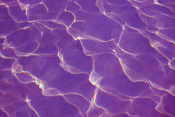 Amazing pop art surreal purple colored water surface reflecting with sunlight for abstract background