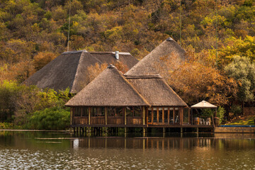 Fototapeta na wymiar thatched roof house on lake in Pretoria South Africa