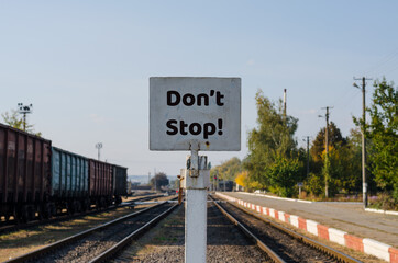 "Don't Stop!" sign on the railway station
