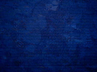 Background from the embossed surface of roughly painted blue paint with uneven saturation