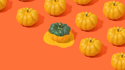 Minimal composition pattern with half painted dark green  pumpkin and orange liquid on bright red table. Trendy surreal autumn wallpaper with diagonal copy space.