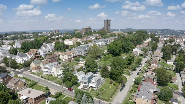 A slow forward-motion aerial establishing shot of the Duquesne Heights neighborood on Pittsburgh's Mount Washington.  	