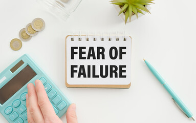 businesman hold notepad with text Fear of Failure White background. Business