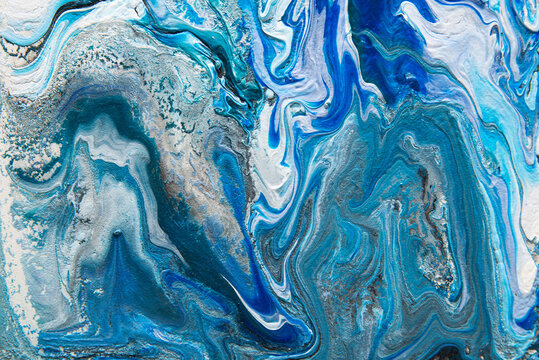 Texture in the style of fluid art. Abstract background with swirling paint effect. Liquid acrylic paint background. Blue, turquoise, white and gray colors.