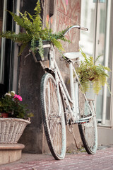 Fototapeta na wymiar Art bike decoration with flowers outside of a shop