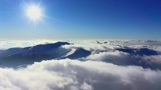 Wonderful view of extraordinary cloudy valley and bright orange sunset