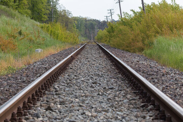 Fototapeta na wymiar Railroad tracks, railroad rails, two parallel rails on which the train runs. A straight road somewhere far away