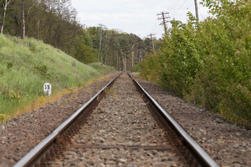 Fototapeta premium Railroad tracks, railroad rails, two parallel rails on which the train runs. A straight road somewhere far away