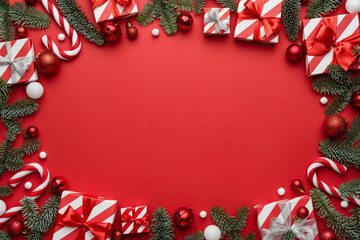 Red Christmas background with frame decorated with holiday gifts
