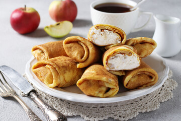 Homemade thin pancakes with cottage cheese and apples for breakfast