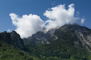 Shady rocky mountains in the Alps with cloudy sky, Austria