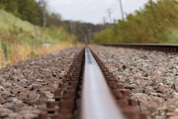 Fototapeta premium One metal railroad track, straight road ahead, railroad road construction, road to destination