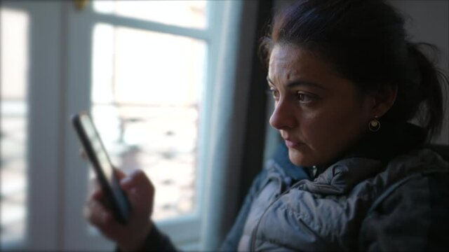 Woman reading message content online with cellphone