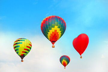 Four bright multicolored balloons against blue sky