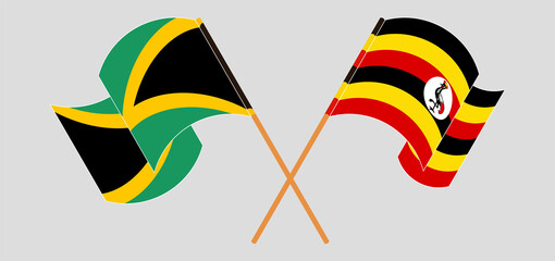 Crossed and waving flags of Jamaica and Uganda