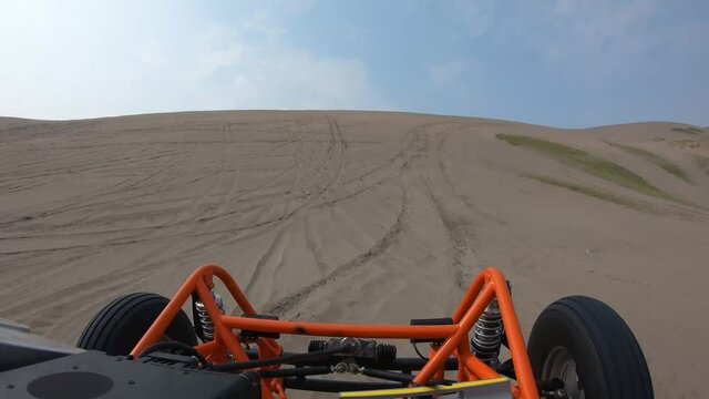 Orange Dune Buggy Driving in the Sand Dunes