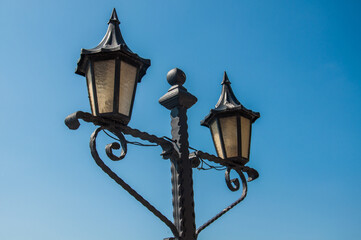 Fototapeta na wymiar Old street light on blue background