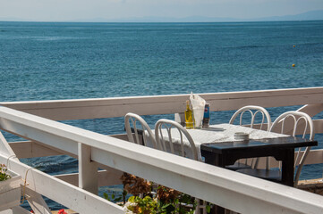 Fototapeta premium Wooden terrace in a restaurant with sea view