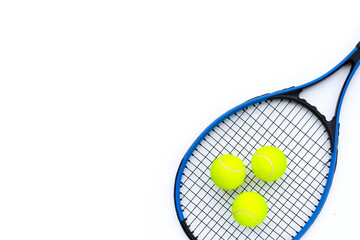 Tennis racket with balls on white.