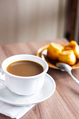 Closeup white cup of coffee cookies and plate on the table office wooden espresso latte cappuccino beverage aroma breakfast mug morning drink hot spoon sweet dessert
