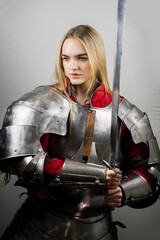 A beautiful warrior woman  with a sword and in armor, Medieval knight