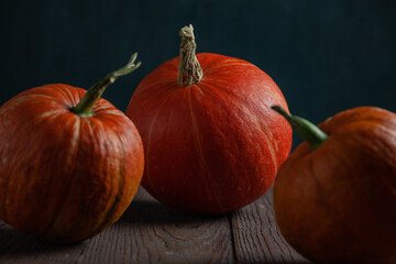 Pumpkins on wooden table in dark mood.